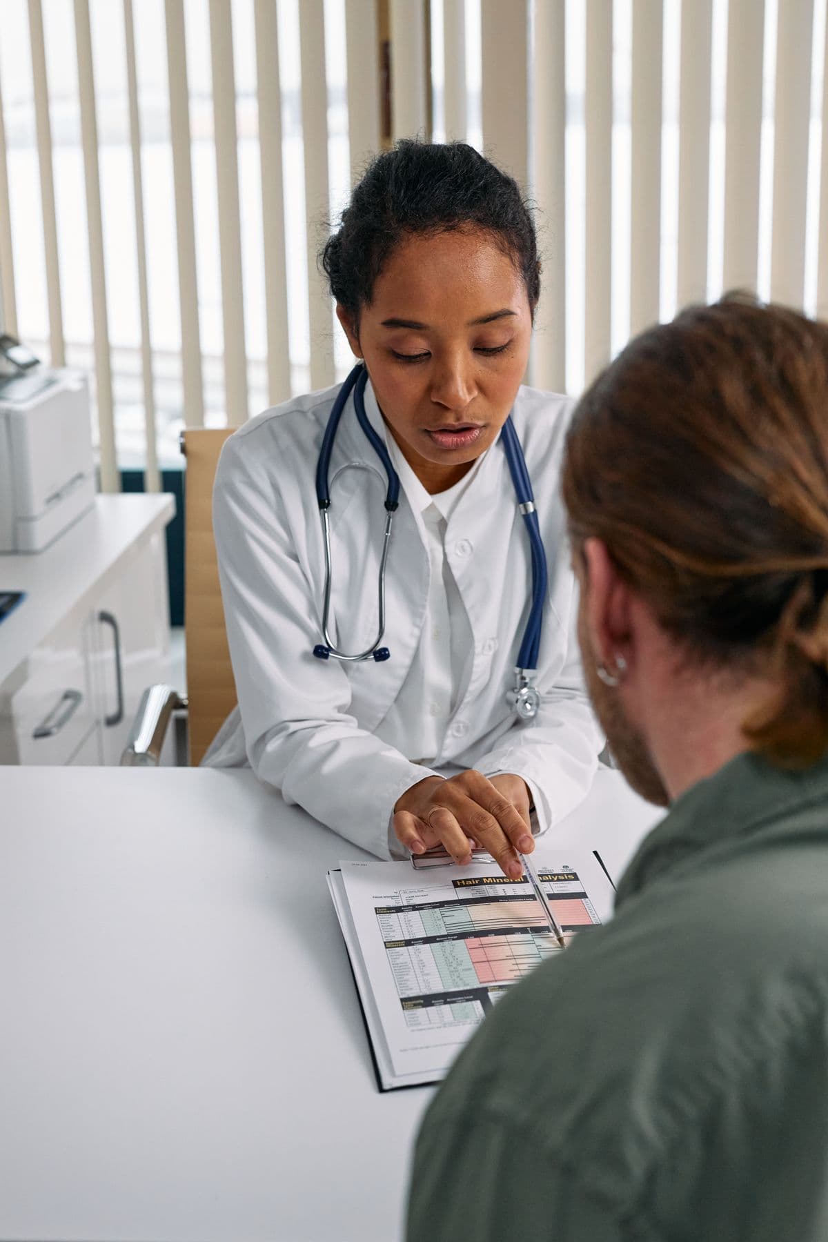 Doctor reviewing a health chart during a thorough consultation